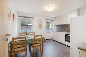 a kitchen with a table and chairs and a refrigerator at Haus Annenberg in Monzelfeld