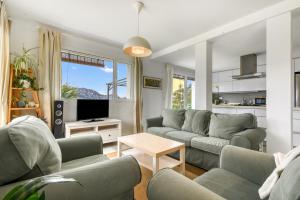 a living room with two couches and a tv at Villa Sol in Orba