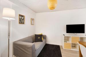 a living room with a couch and a flat screen tv at Prestigegoldresidence 1 - Old Town in Guimarães +16 photos