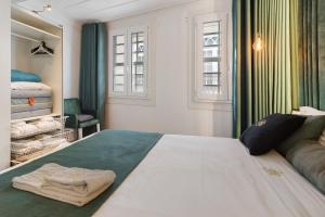 a bedroom with a large bed with towels on it at Prestigegoldresidence 1 - Old Town in Guimarães