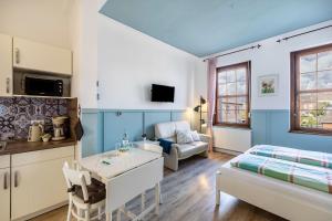 a kitchen and living room with a bed and a table at Schweden Apartment in Kerken