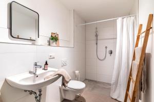 a white bathroom with a sink and a toilet at Fewo Kleines Glück in Friesenheim +14 photos