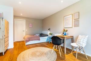 a bedroom with a bed and a desk and a table at Fewo Kleines Glück in Friesenheim