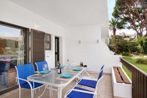 a dining room with a table and chairs on a balcony at Mouramar Vilamoura in Vilamoura