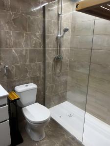 a bathroom with a toilet and a shower at Mouramar Vilamoura in Vilamoura +11 photos