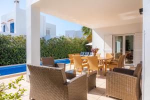 an outdoor patio with a table and chairs at Villa Costa Eugenia in Cala d´Or