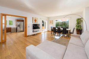a living room with a white couch and a table at Villa Costa Eugenia in Cala d´Or