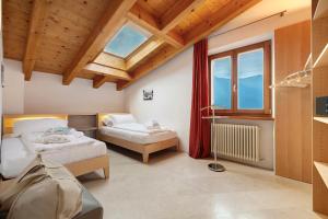 a bedroom with two beds and a window at Ca dela Nua front lake in Limone sul Garda