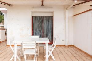a white table and chairs on a patio at Appartamento A - Le Terrazze in Ribera