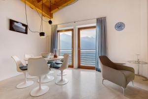 a dining room with a table and chairs and a clock at Ca dela Nua front lake in Limone sul Garda