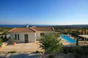 a villa with a swimming pool and a view at Villa Linatela Ideales Resort in Kefallonia