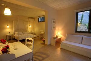 a living room with a couch and a bed at Villa Linatela Ideales Resort in Kefallonia