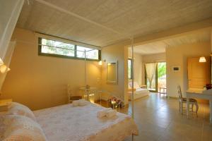 a bedroom with a large bed with towels on it at Villa Linatela Ideales Resort in Kefallonia +15 photos