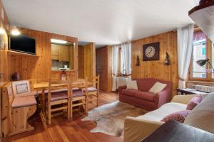 a kitchen and dining room with a table and chairs at Apartment Corti Garden in Campodolcino