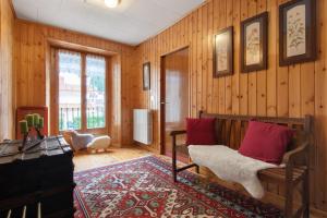 a living room with wood paneling and a couch at Apartment Corti Garden in Campodolcino