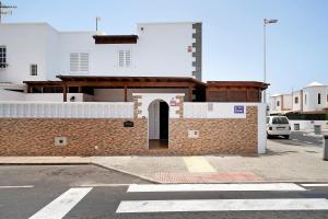 a brick building with a door on a street at Casa Cordel in Playa Honda