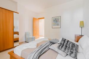 a bedroom with a bed and a chair in it at Casa vacanze Laura in centro in Otranto