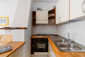 a small kitchen with a sink and a stove at Casa vacanze Laura in centro in Otranto