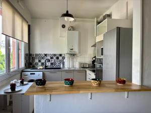 a kitchen with a wooden counter with bowls on it at Ty Foch in Lorient