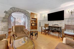 a living room with a fireplace and a flat screen tv at Secluded House - Quinta La Rabide in Azeitao