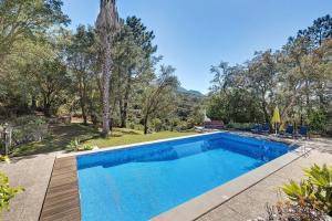 a swimming pool in a yard with trees at Secluded House - Quinta La Rabide in Azeitao