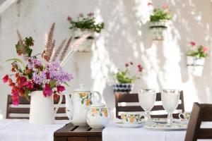 a table with flowers in vases on top of it at Liberal Wing Villa in Portimão +30 photos