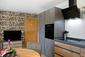 a kitchen with a wooden table and a counter top at Ferienwohnung Krummel in Edertal