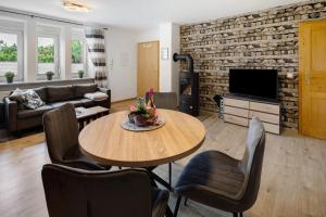 a living room with a table and chairs at Ferienwohnung Krummel in Edertal