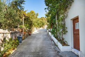 an empty street with trees and a building at Elysium in Glinádhon