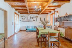 a kitchen and dining room with a table and chairs at Ciumara East in Avola