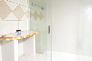 a bathroom with a shower with a glass door at Elysium in Glinádhon
