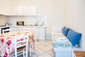 a living room with a table and a kitchen at Elysium in Glinádhon