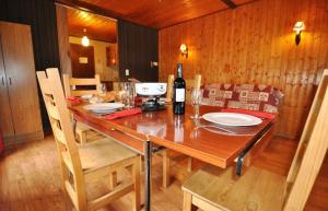 a wooden table with a bottle of wine on it at Le Mont de Grange in La Chapelle-dʼAbondance +7 photos