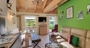 a living room with green walls and a couch at Ferienwohnung Sonnenschein in Nagel