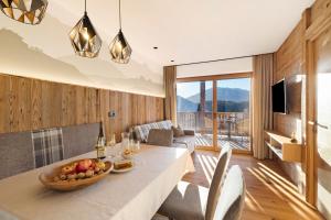 a living room with a table with a bowl of fruit on it at Lechnerhof - Clara´s Mountain Lodge in Rodengo