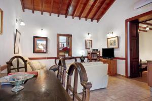 a living room with a table and a couch at Casa De La Eterna Primavera in San Bartolomé