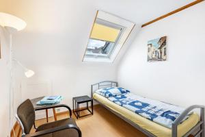 a bedroom with a bed and a table and a window at Gita in Öhningen