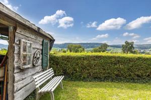 a wooden building with a bench in front of it at Gita in Öhningen