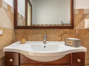 a white sink in a bathroom with a mirror at Maison Pinella in Villasimius +23 photos