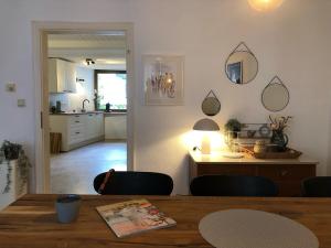 a kitchen and dining room with a table and chairs at das rote Ferienhaus Terlinden in Lieser