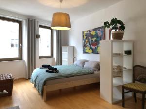a bedroom with a bed in a room with windows at das rote Ferienhaus Terlinden in Lieser