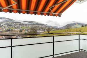 a balcony with a view of the mountains at Fewo Schwarzwald - Haus Sommerberg in Baiersbronn