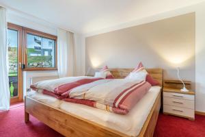 a bedroom with a bed and a window at Fewo Schwarzwald - Haus Sommerberg in Baiersbronn