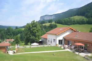 a house with a large yard in the mountains at La Chambre De Jaxel in Saint-Martin-en-Vercors