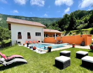 a house with a yard with a swimming pool at La Chambre De Jaxel in Saint-Martin-en-Vercors