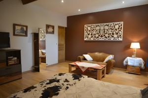 a room with a bed and a couch and a table at La Chambre De Jaxel in Saint-Martin-en-Vercors