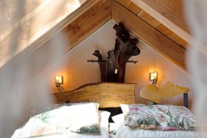 a bed in a room with a wooden ceiling at La torretta di Mozzola in Oggebio