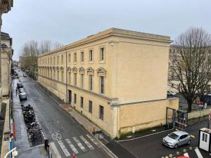 a large yellow brick building on a city street at Chez Guillaume in Bordeaux