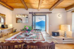 a dining room table with a view of the ocean at La torretta di Mozzola in Oggebio
