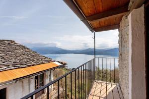 a balcony with a view of a body of water at La torretta di Mozzola in Oggebio